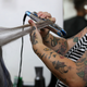 A salon worker using a curling iron.